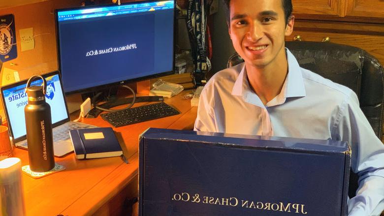 Victor Ficarra holds his welcome package from J.P. Morgan. 